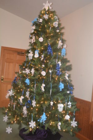 Annabelle Border, along with volunteers, decorates the tree at Prairie Chapel for January. Border has a theme for the tree each month. Beth Scott | Beacon