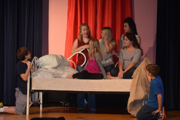 Maria (Trudy Oswald) comforts the Von Trapp children during a thunder storm in the Ridgewood High School production of “The Sound of Music” which will be performed April 7 – 9 at the high school. Beth Scott | Beacon