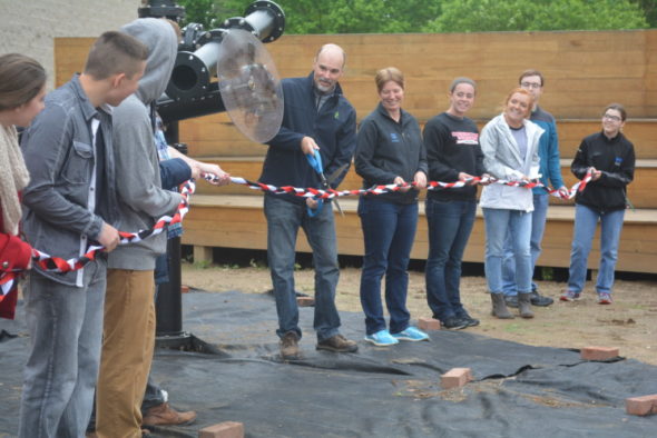 Dr. David Hire, center, superintendent of Coshocton City Schools, cuts the ribbon during the opening of the new art piece at the artPark on Friday, May 5. Beth Scott | Beacon