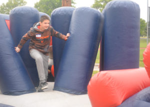 Coen Bible from River View Junior High is pictured working his way through the National Guard obstacle course set up at Youth Health Day on May 11 at Kids America. Josie Sellers | Beacon