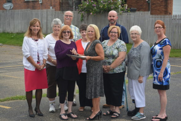 Coshocton Community Housing Inc. recently donated property to First Step Family Violence Intervention Services, Inc. Board members from both organizations gathered together on July 27 to celebrate the occasion. Pictured from left in row one are – Laura Miller, vice president for community housing; Mary Mason, president for community housing; Vicki Laudick Casey, executive director of First Step; Jill Lahna, vice president of First Step’s board; Tomma Bordenkircher, First Step board member; Carey McMasters, First Step board member; and in back are – Carolyn Karr, secretary/treasurer for community housing; Steve Champagne, from community housing; Mary Tracy, First Step board treasurer; and Rob McMasters, First Step board member. Josie Sellers | Beacon