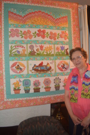 Mary Ann Lampe stands by her gardening quilt she made for the 2016 Coshocton Canal Quilters show. 