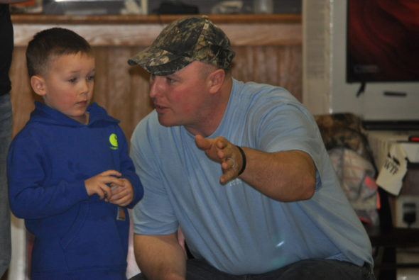 Keegan (left) and Nic Carey were enjoying themselves at the 28th annual Muskingum Valley Chapter of the NWTF Hunting Heritage banquet held March 4 at Lake Park Pavilion. One of the highlights of the evening is a gift to each youth age 17 and under. Nic is giving Keegan some fatherly advice on how the drawing works and some tips on selecting a prize. Mark Fortune | Beacon