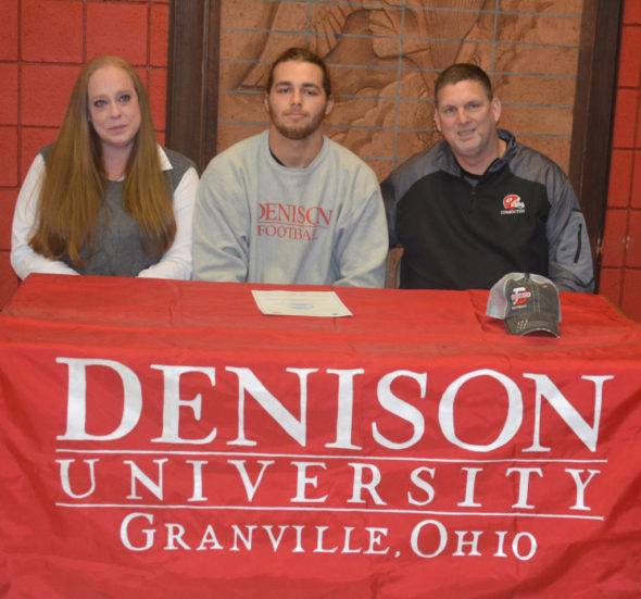 Dallas Griffiths, center, signed his letter of intent to play football at Denison University on Feb. 8 at Coshocton High School. He is pictured with his mother Amber Griffiths and Coshocton’s head football coach Jim Woodrum. Josie Sellers | Beacon