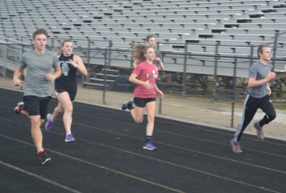 Members of River View High School’s indoor track team warm up on the track during practice on Feb. 23. Josie Sellers | Beacon 