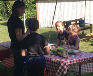 Instructor Emily Adams talks with kids during the Fourth annual Local Foods Kids Cooking Camp at Local Bounty Coshocton on Tuesday, Aug. 9.  Andrew Everhart | Beacon