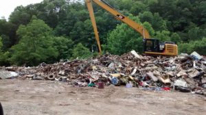 This is one of the scenes Cindy Gray saw while delivering supplies to flood victims in West Virginia. This pile of debris was flooded onto the highways and had to be pushed off it and loaded onto dump trucks. Contributed | Beacon