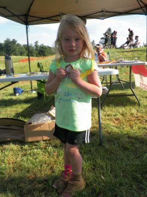 Aspen, 3, was the first child to complete the children’s course and she was excited about her medal – and her muddy shoes. Jen Jones | Beacon