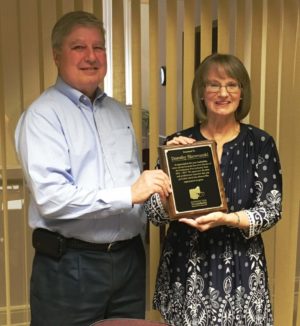 Dorothy Skowrunski is pictured at right with Robert Simpson, owner of MFM and the Coshocton Port Authority Board Chairman. Simpson presented Skowrunski with a plaque honoring her for her years of service as the port authority’s executive director. Contributed | Beacon