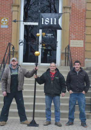 Brad Birkhimer (center) was asked to create a weathervane for the Coshocton County Courthouse. Pictured with him are his sons BJ (left) and Richard (right) who Brad said helped some with the assembly and the design, but were definitely going to help him mount it to the top of the courthouse. Josie Sellers | Beacon