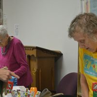 Women at First Baptist Church pack boxes for Operation Christmas Child