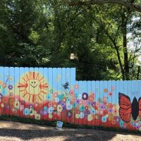 Local artists add colorful backdrop to children’s area at Clary Gardens